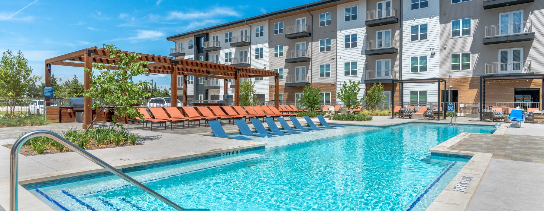 pool with outdoor grill area and resort-style seating