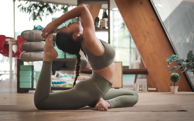 a woman doing yoga on mat